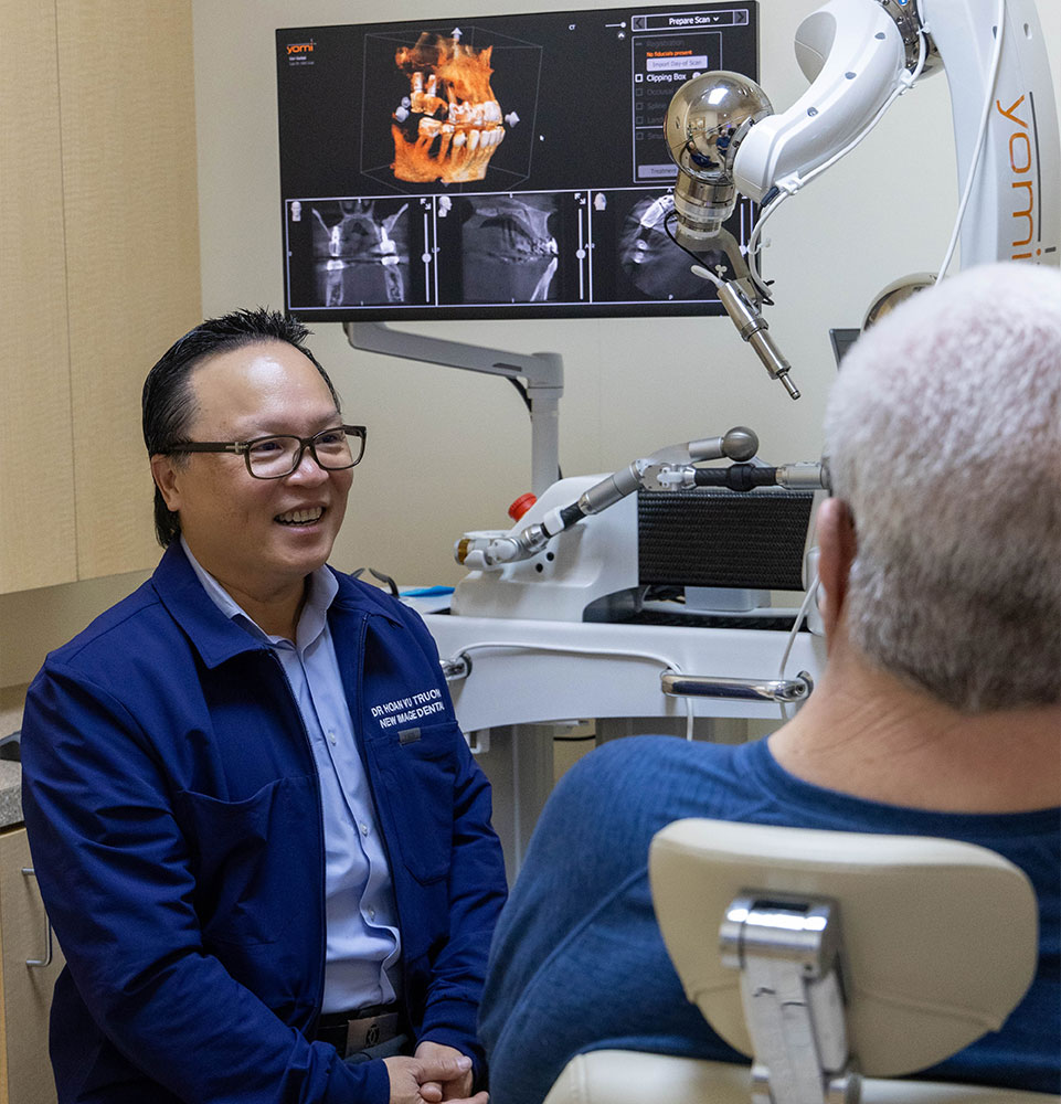 Dr. Truong having a consultation with a patent about full mouth dental implants