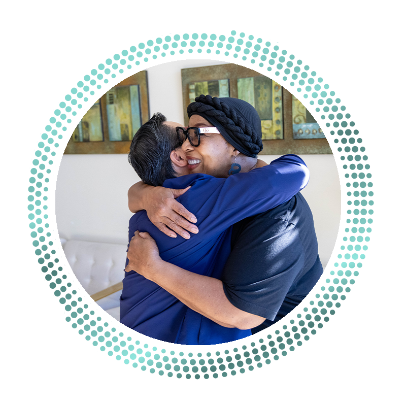patient hugging Dr. Truong after he helped fix her smile