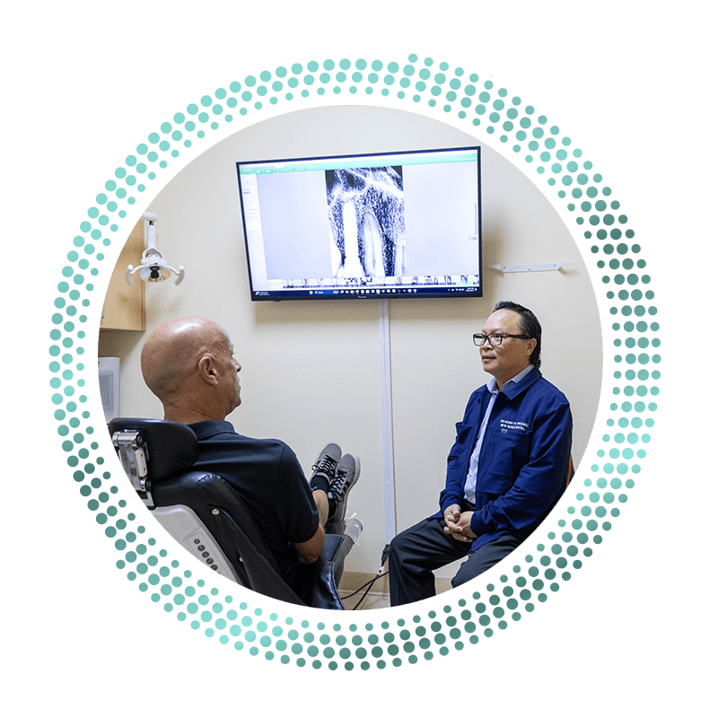 Dr. Truong consulting with patient about dental implants