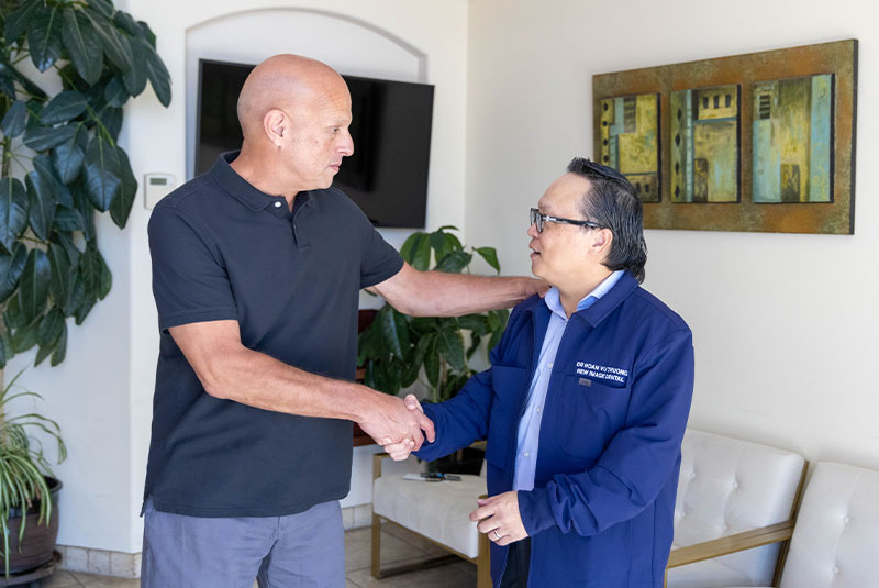 Dr. Truong. giving a patient a hand shake