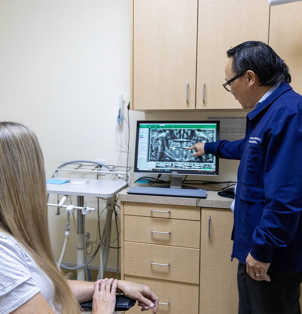 Dr. Truong telling patient what will happen for the full mouth reconstruction procedure