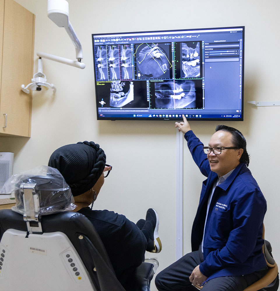 Dr. Truong going over x-ray with. patient that needs a root canal
