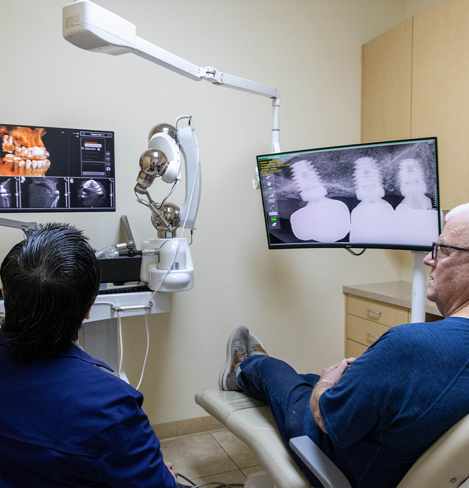 Dr. Truong going over conditions he treats with customer
