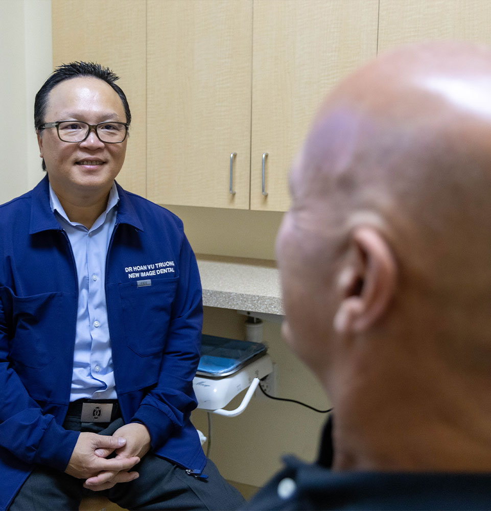 Dr. Truong. talking to patient about Porcelain veneers