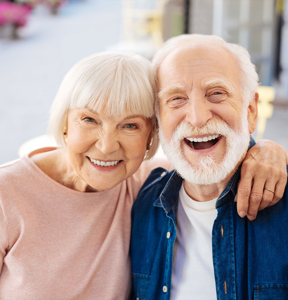 couple smiling after getting dentures