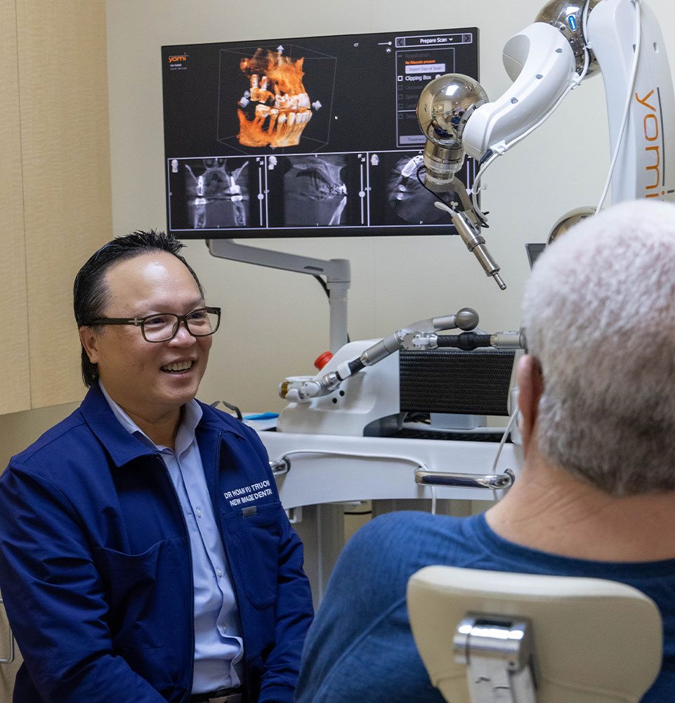 dr truong with dental patient and yomi robot