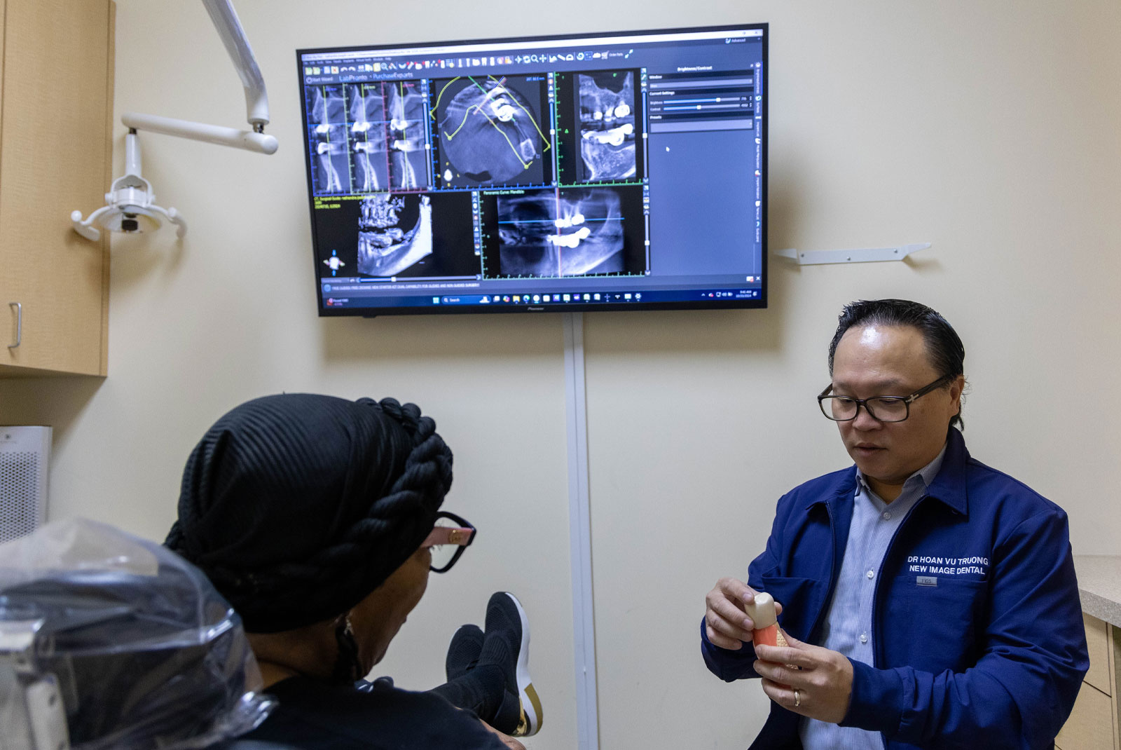 dr truong with dental implant model and dsd behind him